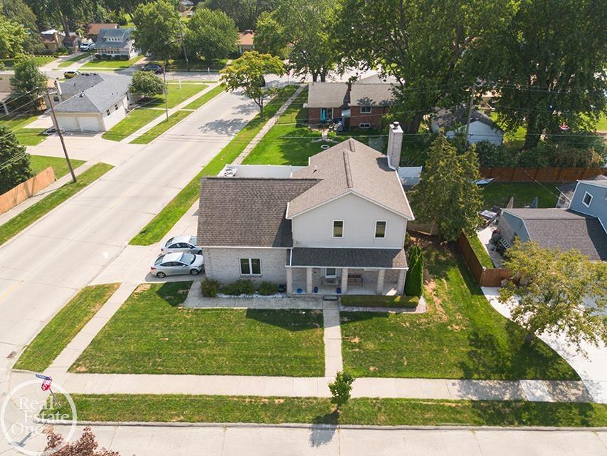 Aerial real estate photo of 22212 Mylls Ct in St. Clair Shores showing corner lot, front lawn, driveway, and neighborhood streets.
