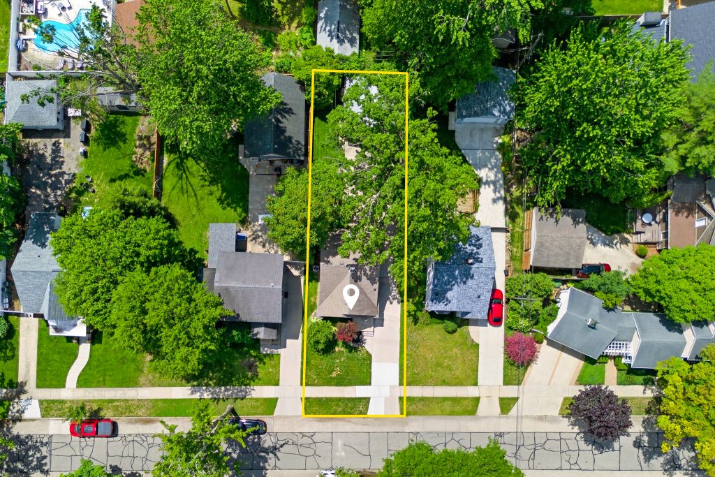 Top-down aerial of a Royal Oak property with lot boundary highlighted around the house, driveway, trees, and detached garage.
